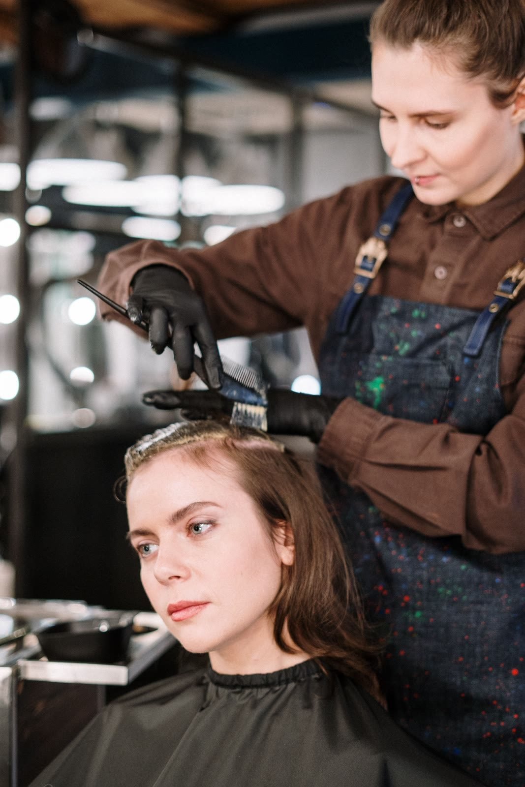 A colourist applying hair colour at Lavish Looks in Northampton