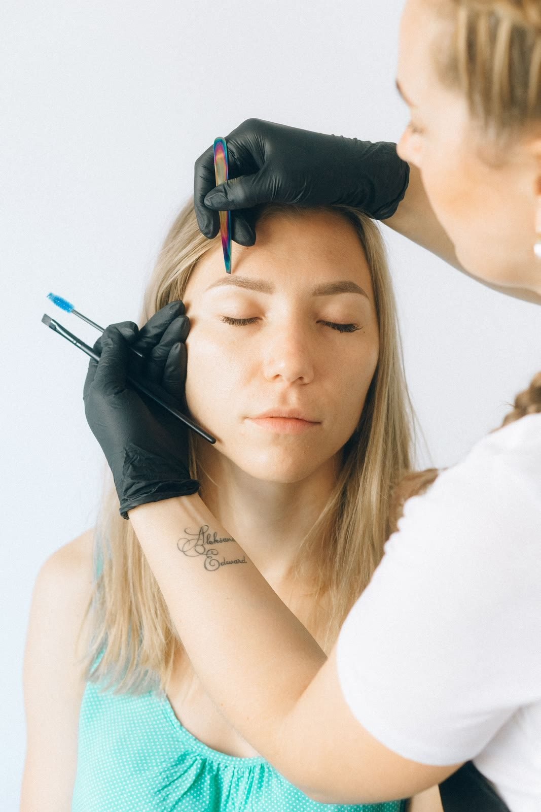 A therapist shaping a client's brows at Lavish Looks in Northampton