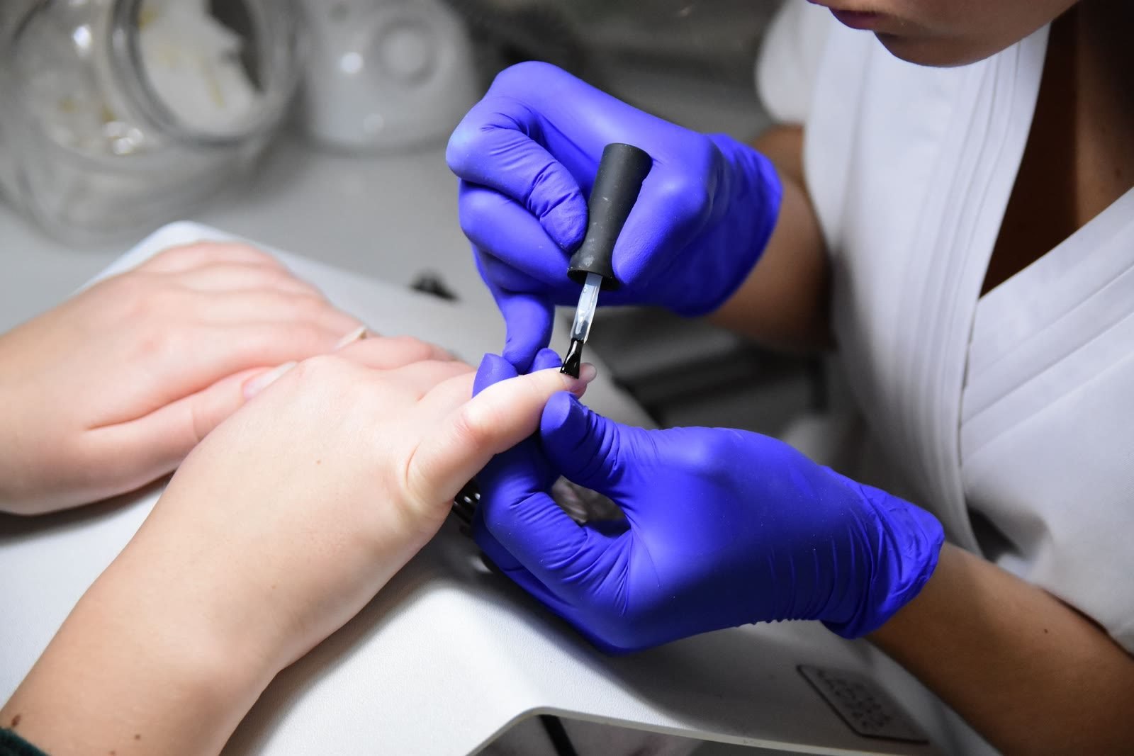 Nail polish being applied during a manicure at Lavish Looks